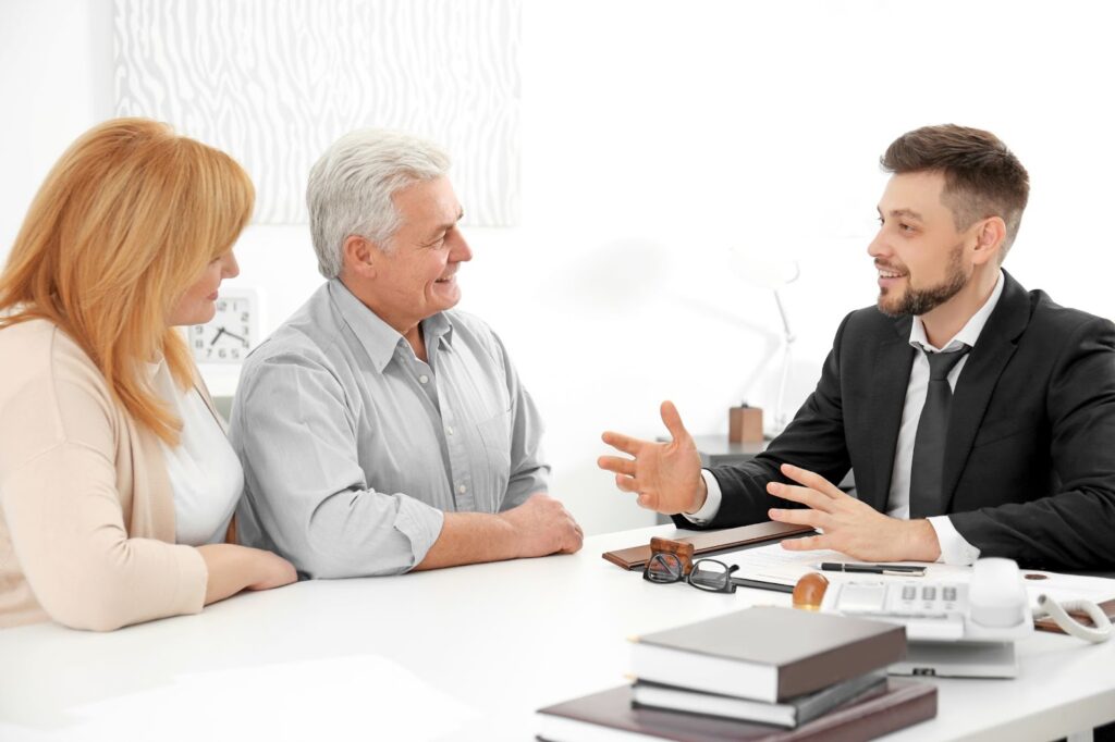 A senior couple discuss their affairs with an elder law attorney